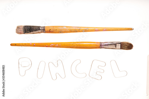 different used paintbrushes on white background