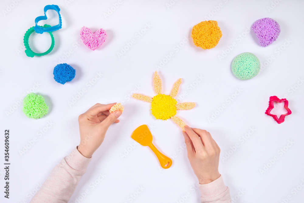 Girl playing playfoam at home isolated on white background. Girl playing playfoam at home isolated on white background.