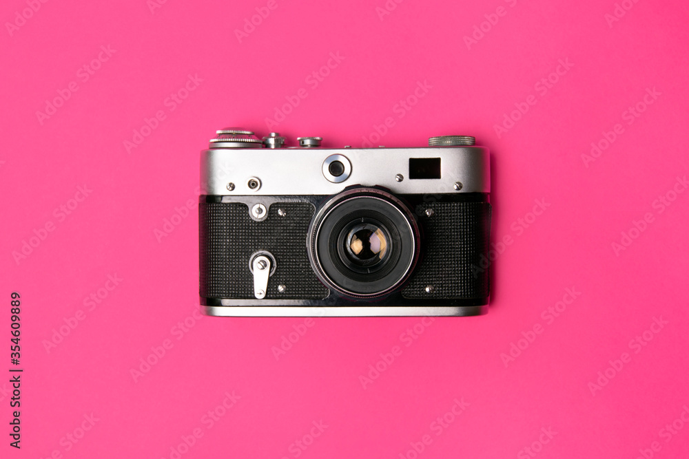 Retro camera isolated on bright pink background Retro camera isolated on bright pink background