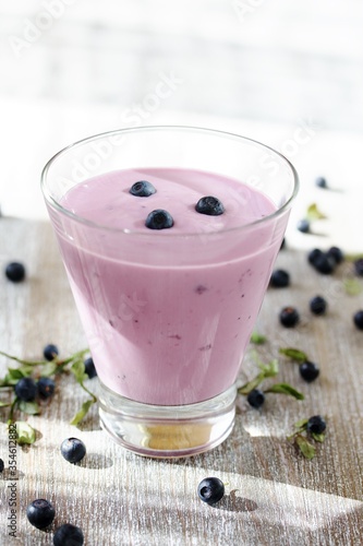 Drinking blueberry yogurt.. yoghurt drink with blueberries in the bank and forest berries blueberry. 
