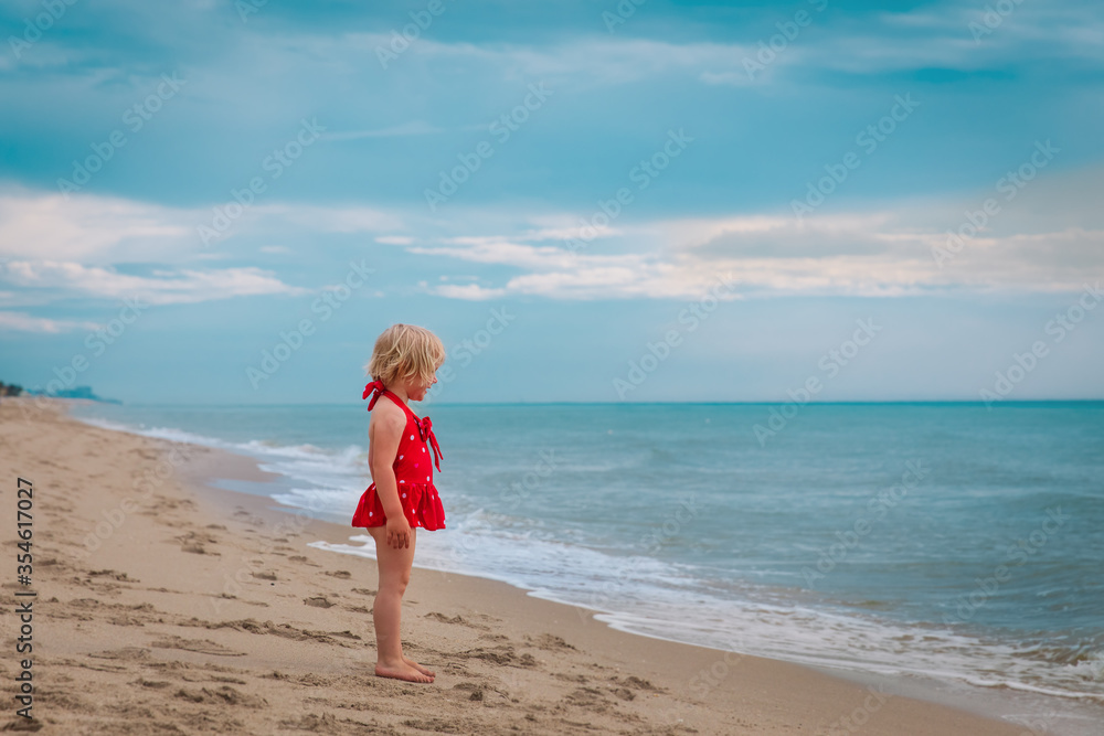 little girl go to swim on tropical beach