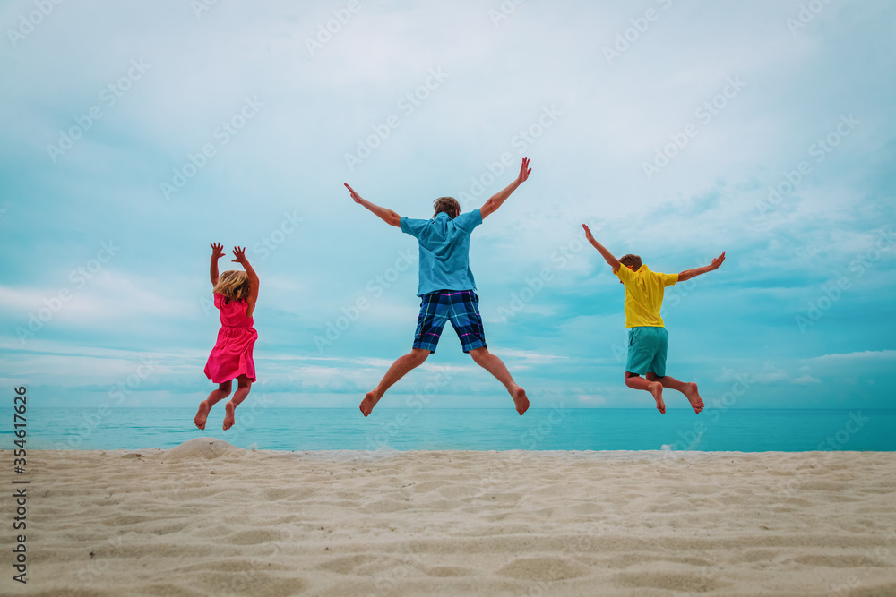 happy father with kids-boy and girl- play at beach