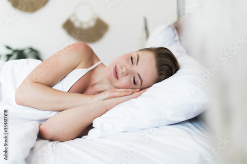 Young beautiful girl sleeps in the bedroom