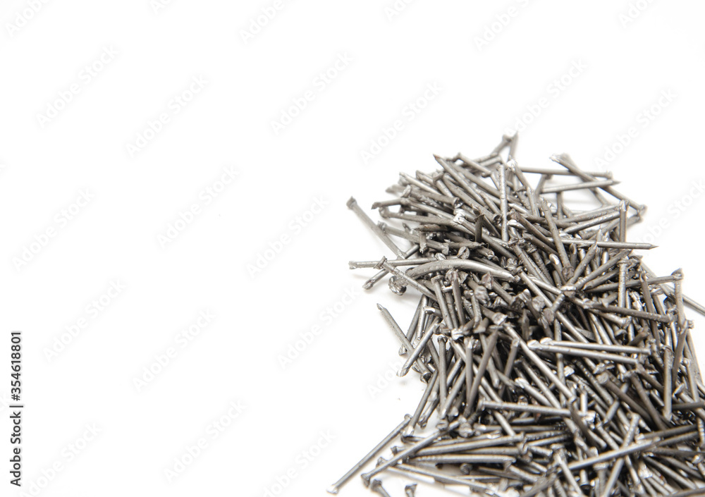 Nail. A pile of nails on a white background in macro. for text. Construction nails Nail. A pile of nails on a white background in macro. for text. Construction nails