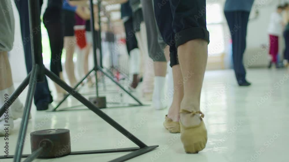 Editorial slow motion shot of ballet dancer in class during practice. Warm-up Editorial slow motion shot of ballet dancer in class during practice. Warm-up