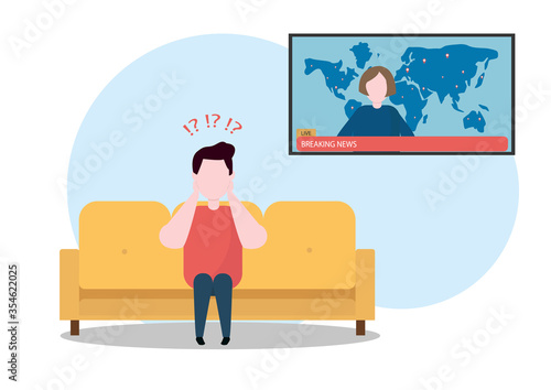 The man is watching breaking news. He does not understand what is happening or is he scared.