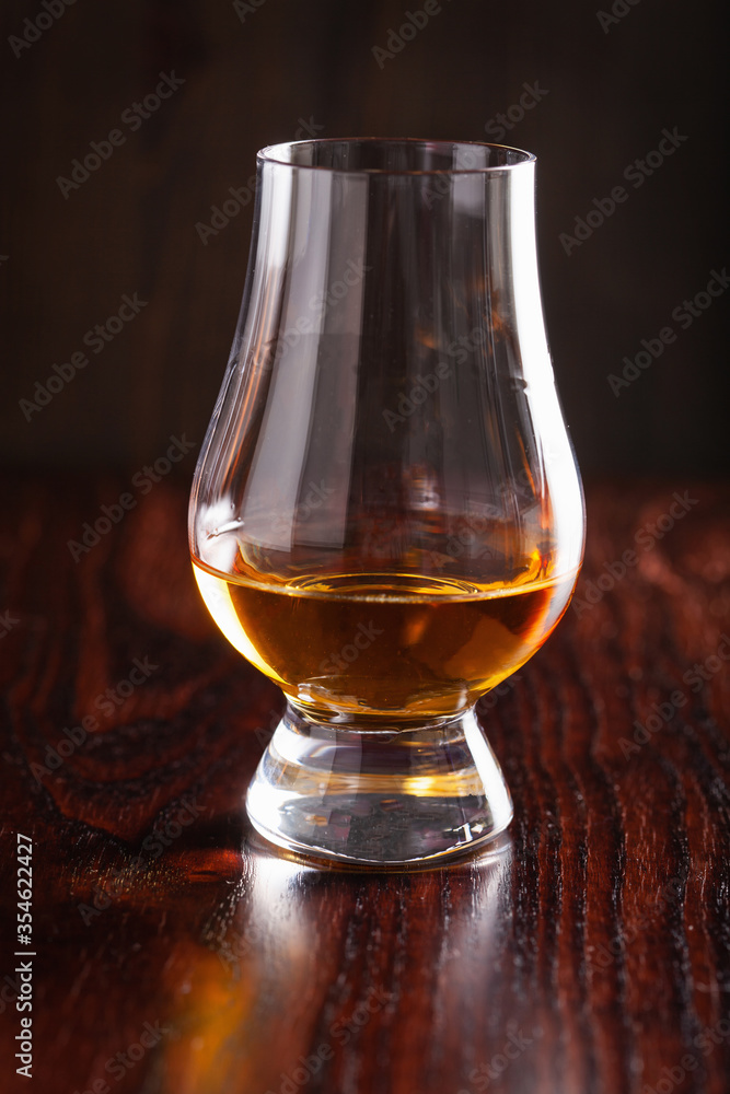 glass of whisky spirit brandy on dark brown background glass of whisky spirit brandy on dark brown background