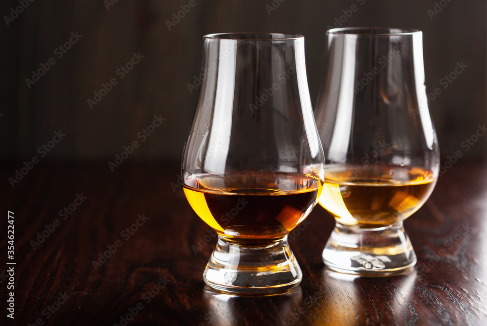 glass of whisky spirit brandy on dark brown background glass of whisky spirit brandy on dark brown background