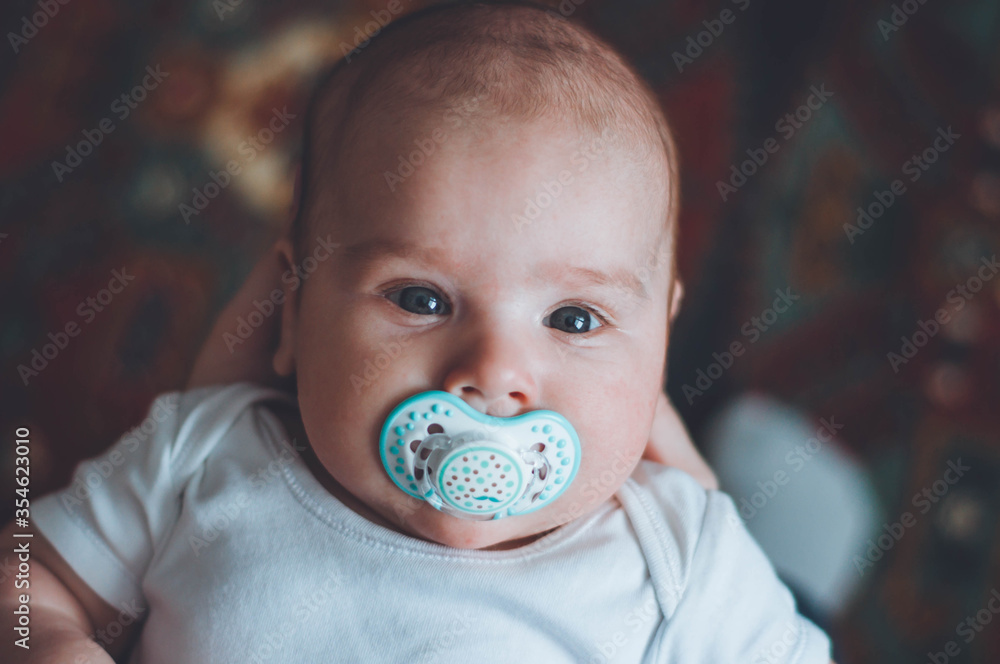 portrait of a little boy. cute baby. three month old boy smiling. baby with a pacifier portrait of a little boy. cute baby. three month old boy smiling. baby with a pacifier