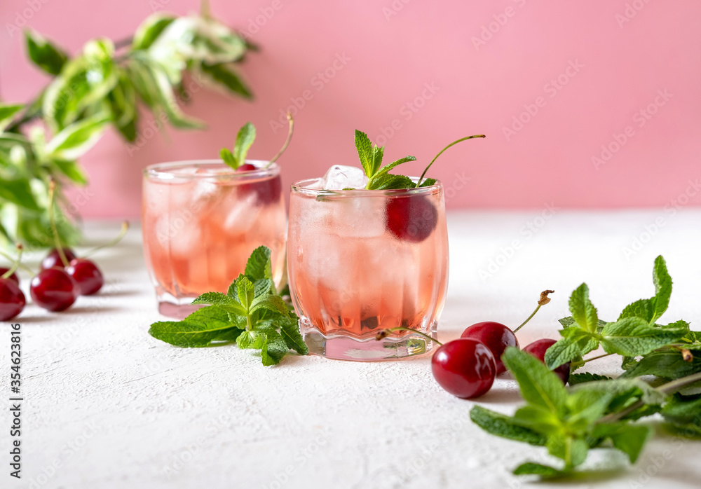 Mocktail with pink syrup and sweetened cherry Mocktail with pink syrup and sweetened cherry