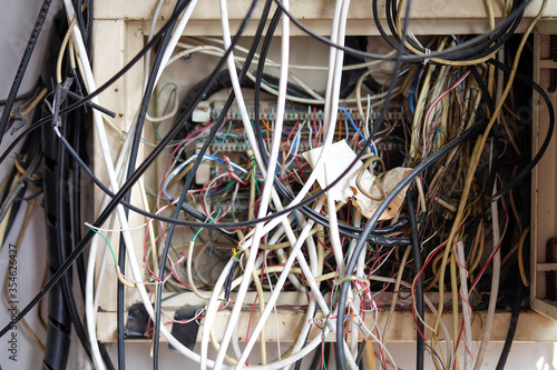 The electrical wires in the box look messy. photo