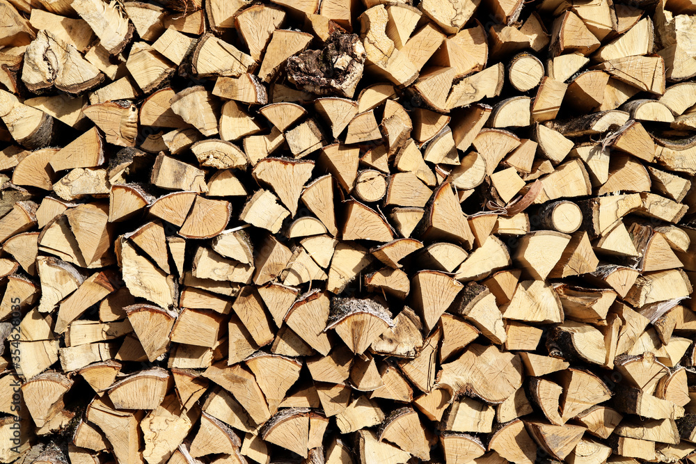 Firewood in a woodpile background. Preparation wood for the winter Firewood in a woodpile background. Preparation wood for the winter