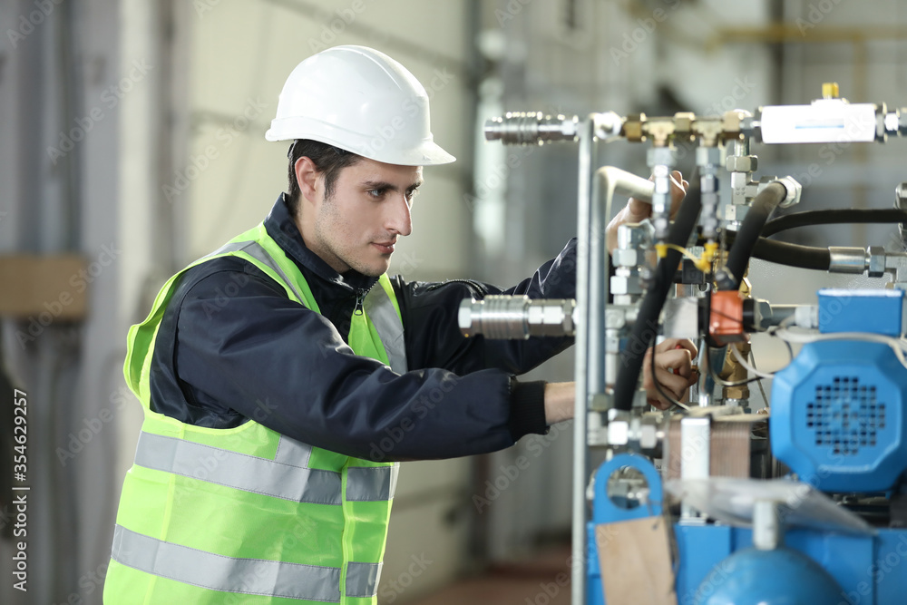 Portrait of a man , factory engineer in work clothes controlling the work process at the airplane manufacturer. Portrait of a man , factory engineer in work clothes controlling the work process at the airplane manufacturer.