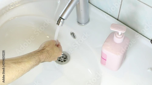 Disinfection of hands with soap in the dressing room. Hand washing rubbed with soap to prevent coronirus. Hygiene to stop the spread of coronavirus.
 photo