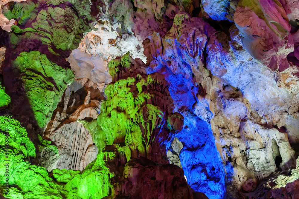 Stalactite and stalagmite formations in a limestone cave of Halong Bay, Vietnam