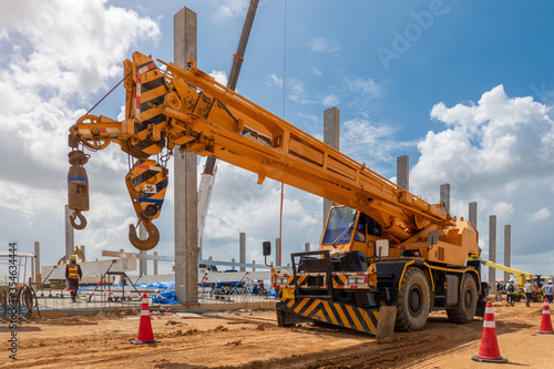 Mobile Crane on a road and tower crane in construction site photo