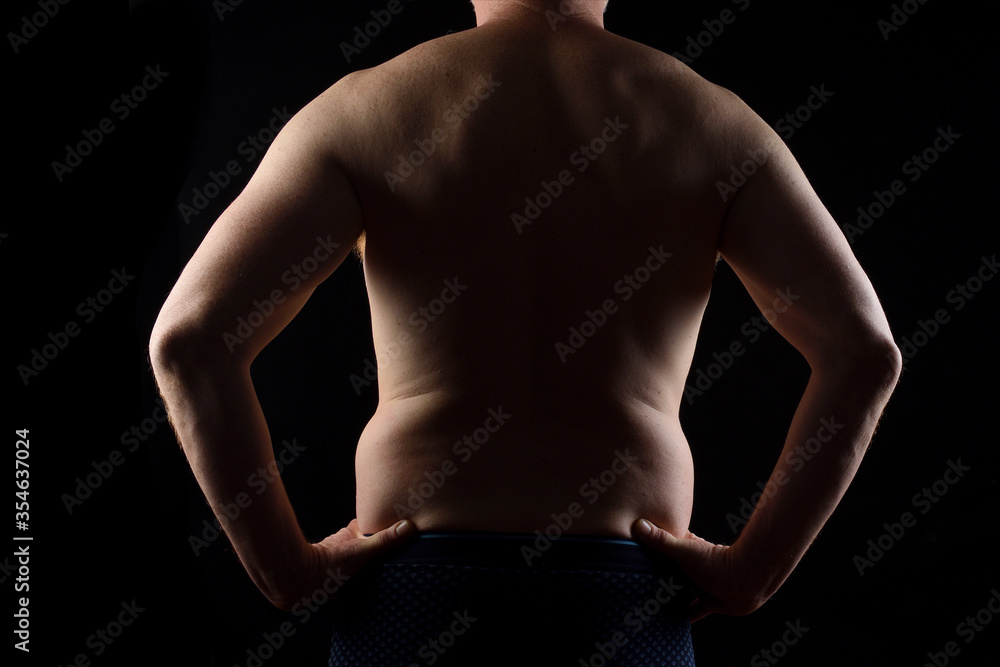 rear view of a man with hands on waist on black background rear view of a man with hands on waist on black background