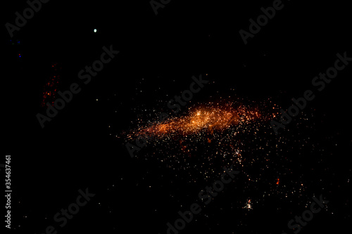 orange vibrant fire particles on a isolated black background