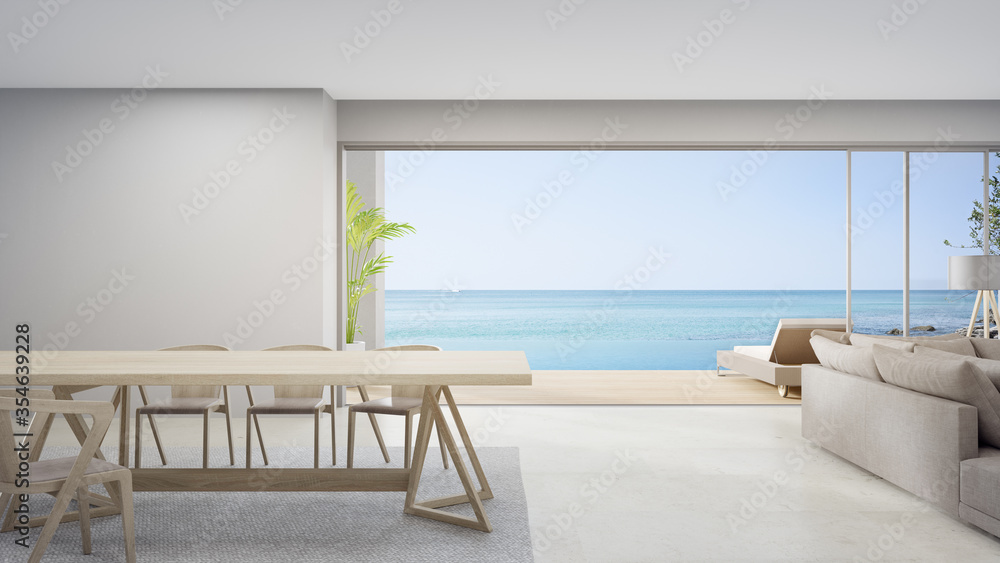 Fototapeta premium Empty table of bright dining room near living room and sofa in modern beach house or luxury pool villa. White home interior 3d rendering with sea view.