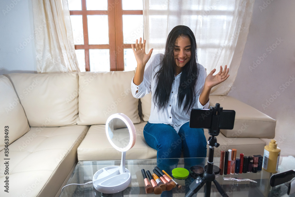 Portrait of a young black woman shooting a makeup video at home. Influential girl online social media marketing live fashion concept Portrait of a young black woman shooting a makeup video at home. Influential girl online social media marketing live fashion concept