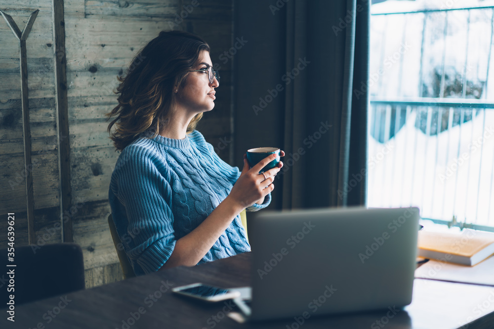 Fototapeta premium Contemplative student pondering on course work during work at netbook