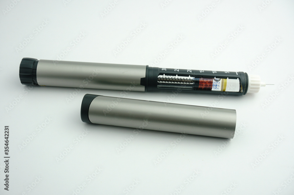 Insulin pen and insulin cartridge isolated on white background.Medical devices is used to self-injection for treatment diabetes disease. Insulin pen and insulin cartridge isolated on white background.Medical devices is used to self-injection for treatment diabetes disease.