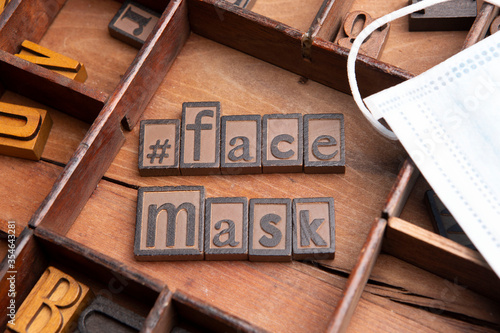 Face Mask in typeset letters along with a medical face mask