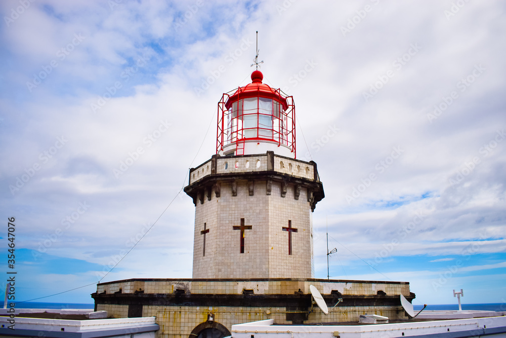 Bright colourful photo of a famous light house on Azorean island, San Miguel island attraction