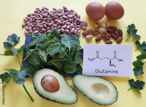 Food rich in glutamine with structural chemical formula of glutamine molecule. Food for training and exercise: spinach, eggs, parsley, avocado, beans, almond, walnut. Bodybuilding, sport nutrition. photo