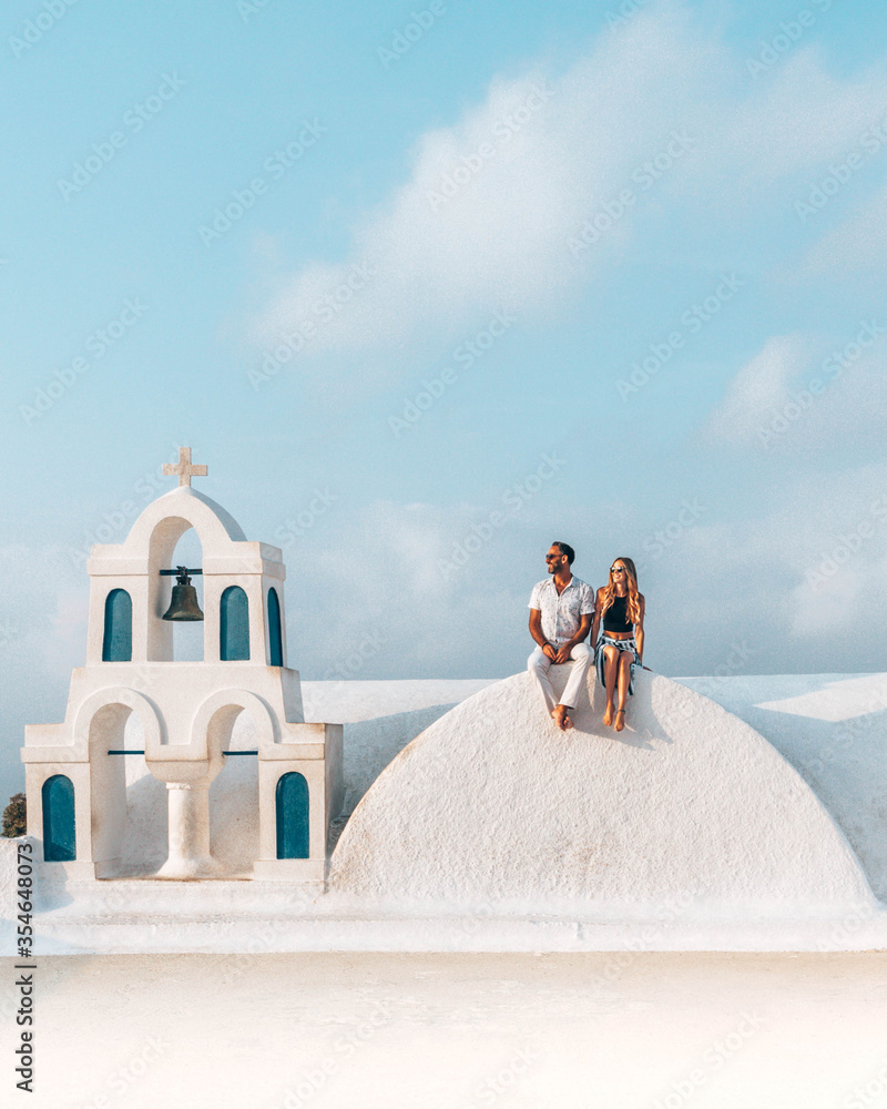 Obraz premium A couple, a bride and groom at Santorini Greece before their wedding.