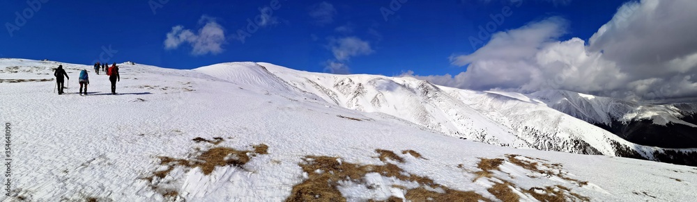 Hiking in the mountains  during winter - panoramic view 