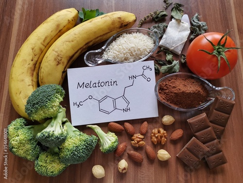 Foods high in melatonin with structural chemical formula of melatonin. Food for good sleep. Melatonin is a hormone; regulates the sleep-wake cycle. Healthy food for better sleep. photo