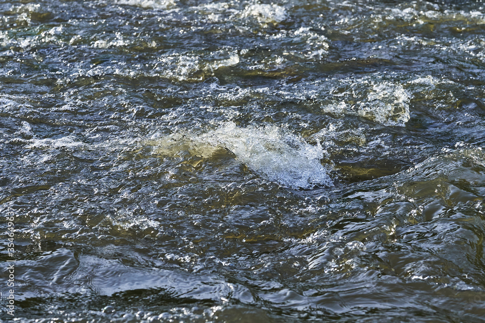 Spray and waves on the surface of the river during a strong wind Spray and waves on the surface of the river during a strong wind