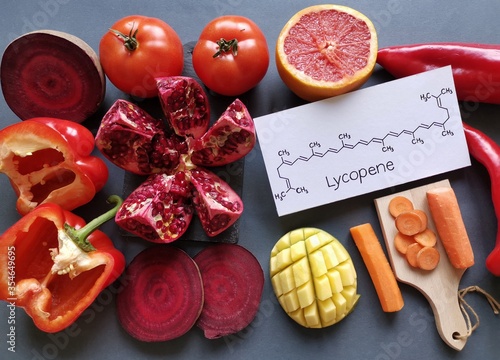 Foods rich in lycopene with structural chemical formula of lycopene molecule. Natural sources of lycopene: tomato, grapefruit, pomegranate, red bell pepper, beetroot, mango and carrot. photo