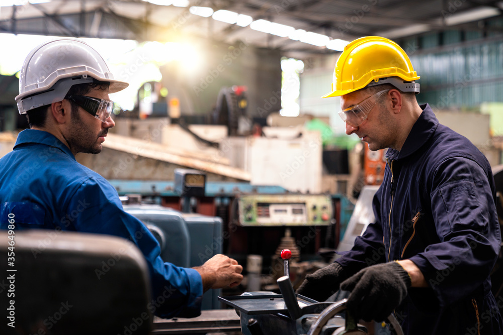 Engineers and technicians are solving problems caused by machines in industrial plants. Young man are working in factory plants. Engineers and technicians are solving problems caused by machines in industrial plants. Young man are working in factory plants.