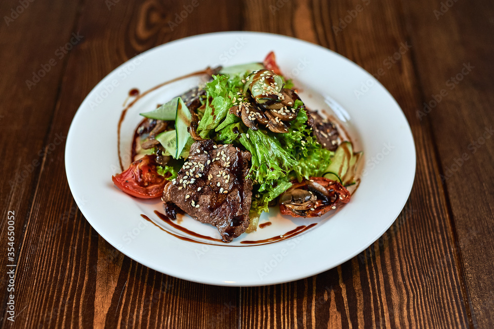 A plate of food sitting on top of a wooden table A plate of food sitting on top of a wooden table