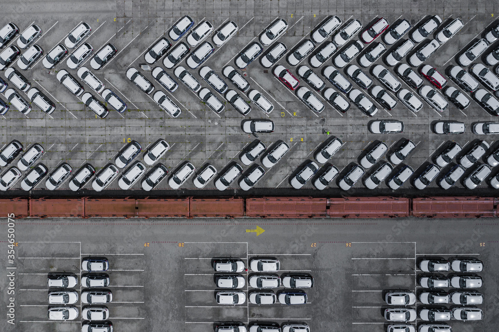 New car lined up aerial view. Port of import and export business logistic to dealership for sale. Automobile and automotive car parking lot for commercial business industry. New car lined up aerial view. Port of import and export business logistic to dealership for sale. Automobile and automotive car parking lot for commercial business industry.