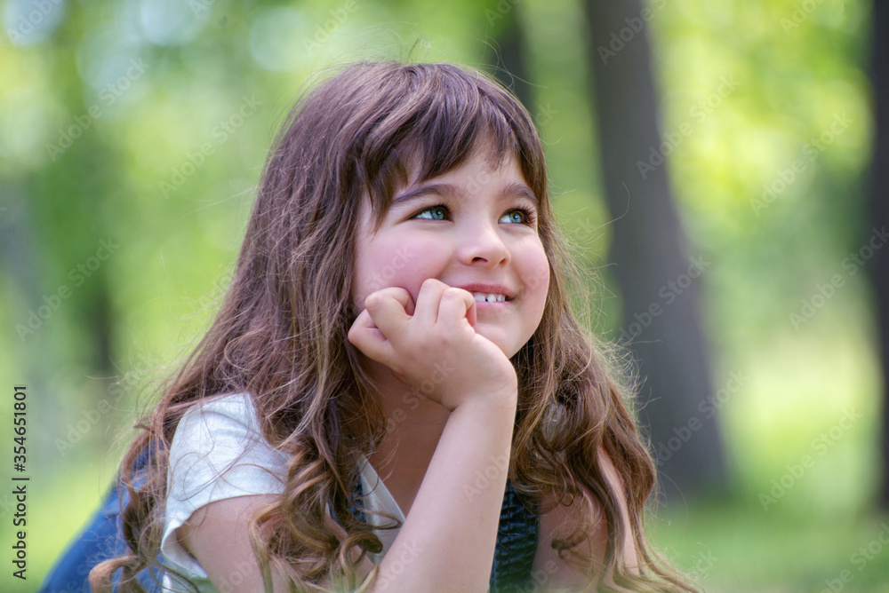 Little girl is biting her nails