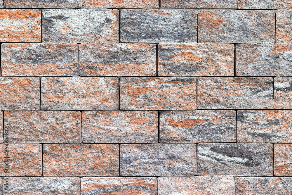 Fototapeta premium Rough bricks fence texture. Stone multicolored wall background