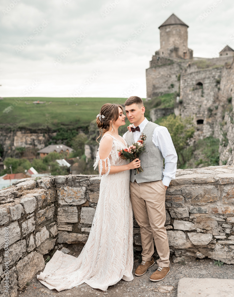 wedding couple. Beautiful bride and groom dancing. Just merried. Close up. Happy bride and groom on their wedding day. Groom and Bride in castle landscape. wedding dress.