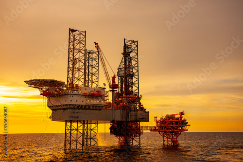 oil drilling rig at sunset