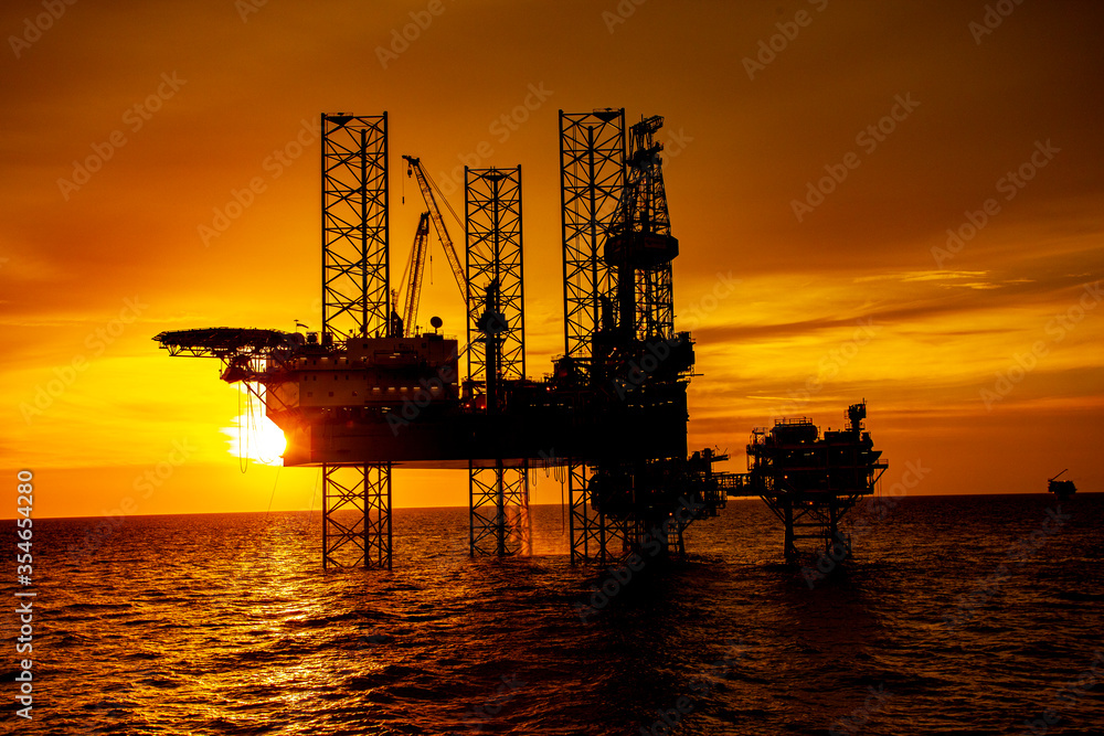 oil drilling rig at sunset
