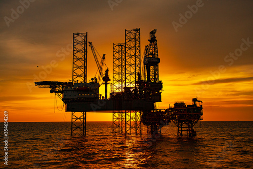 oil drilling rig at sunset