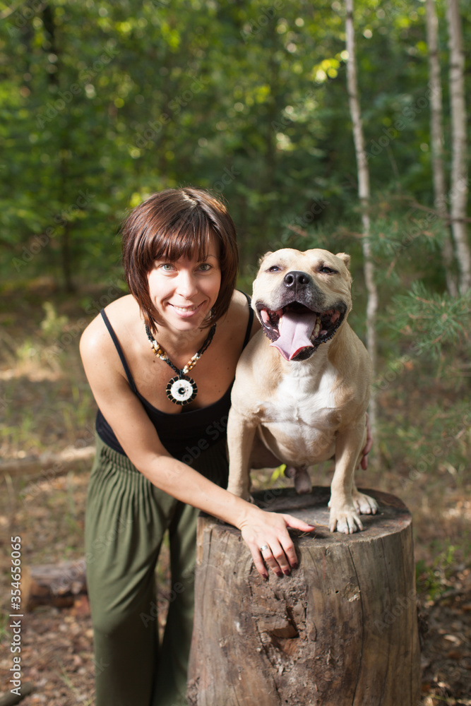 Beautiful women and dog in forest summer time Beautiful women and dog in forest summer time