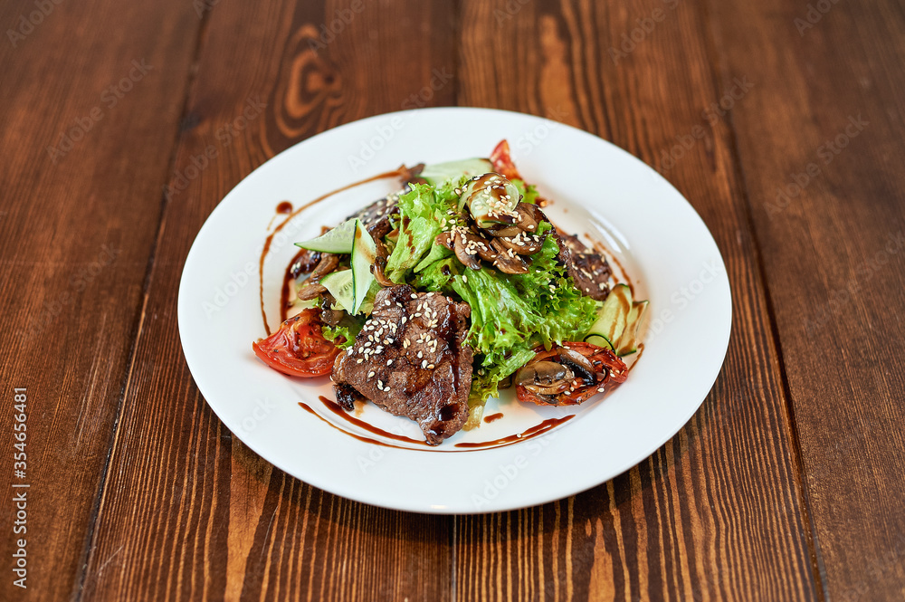 A plate of food sitting on top of a wooden table A plate of food sitting on top of a wooden table