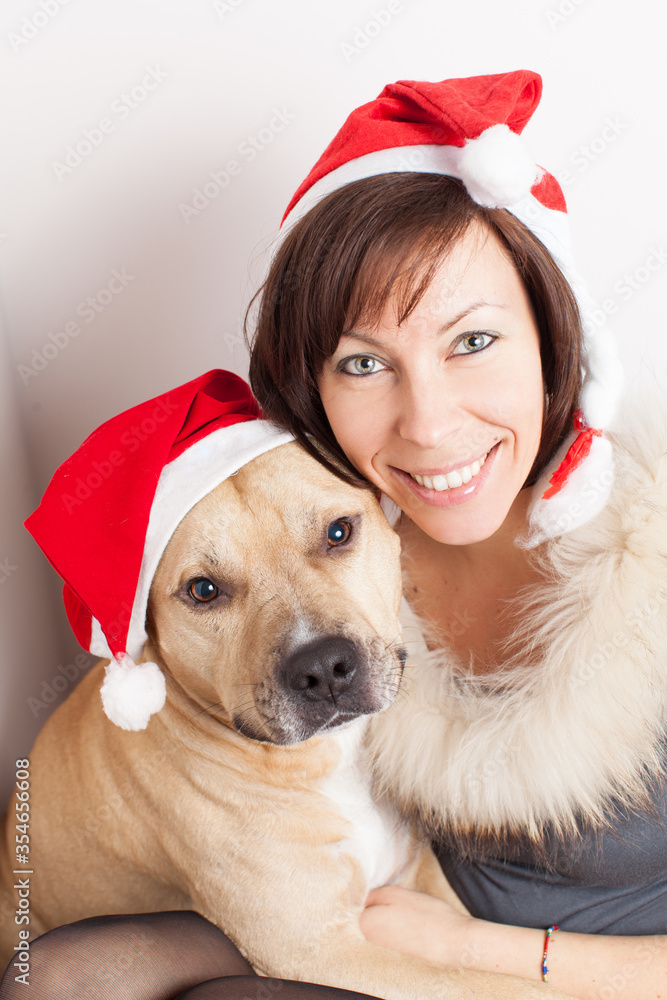 Woman and dog with Santa hat on white background Woman and dog with Santa hat on white background