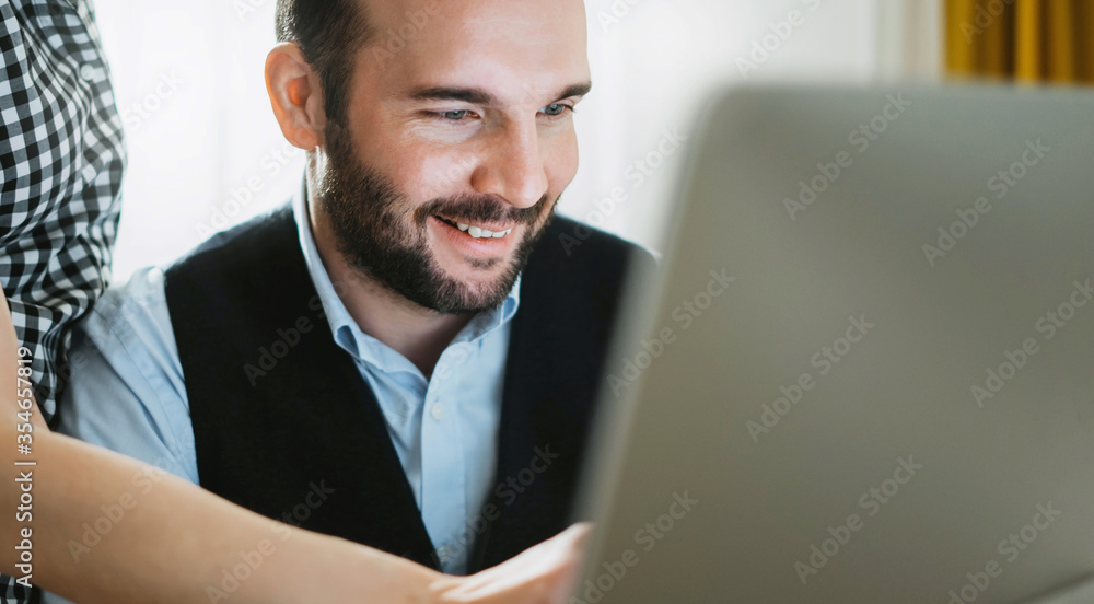 Bearded young businessman working at office. Director man thinking looking in monitor computer. Managers meeting. Idea, alalyze marketing plans. Workplace teamwork concept Bearded young businessman working at office. Director man thinking looking in monitor computer. Managers meeting. Idea, alalyze marketing plans. Workplace teamwork concept