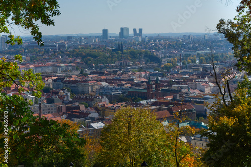 View of Prague through the branches of autumn trees. © Oleksii
