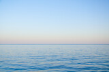 Seascape background calm sea and clear colorful sky at sunset