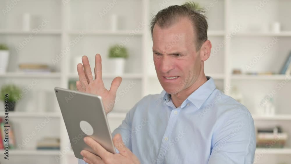 Portrait of Middle Aged Businessman Reacting to Loss on Tablet Portrait of Middle Aged Businessman Reacting to Loss on Tablet